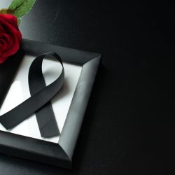 top-view-picture-frame-with-black-bow-dark-wall
